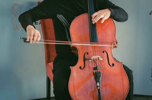 man-sitting-on-chair-and-plating-cello.jpg