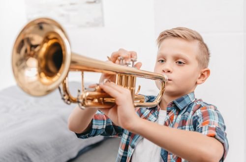 young-boy-practicing-playing-trumpet-in-living-room-at-home.jpg